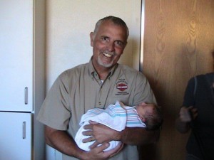 Steve Zohner and his newborn grandchild, location and date unknown | Photo courtesy of Friends of Steve Zohner