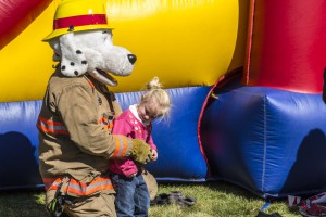 Saiyzha Jimerson gets a hug from Sparky the Safety Dog, Utah State Fire Marshal's mascot, at the Harmony Valley Volunteer Fire Association fundraiser, Apple Harvest Festival, New Harmony, Utah, Oct.12, 2013 | Photo by Jeremy Crawford, St. George News