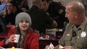 Breakfast was used as a time for the kids and cops to get to know one another. Pancakes, eggs, yogurt, and milk were served for breakfast. KONY Coins for Kids Shop with a Cop, Hurricane, Utah, Dec.14, 2013| Photo by Samantha Tommer, St. George News 