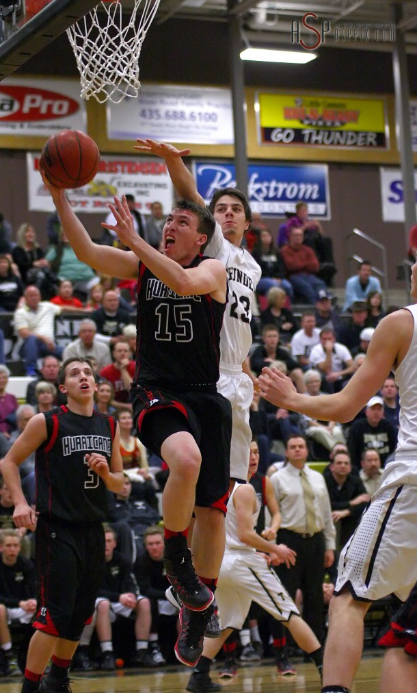 Cody LeBaron (15) shoots past Jordan Hokanson (23), Hurricane at Desert Hills, St. George, Utah, Jan. 31, 2014 | Photo by Robert Hoppie, St. George News