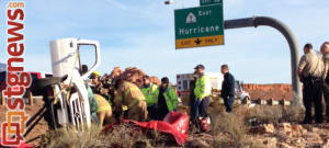 Rescue workers struggle to extricate a man from a vehicle that rolled over on I-15 in Washington. Jan 2, 2014 | Photo by Michael Flynn, St. George News