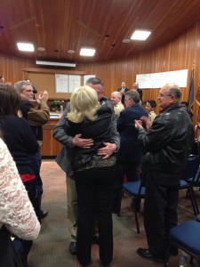 Mayor Dan McArthur hugs his wife, Bunny McArthur during his final city council meeting. St. George City Council chambers, Dec. 19, 2013 | Photo courtesy of Nina DeTorres Heck