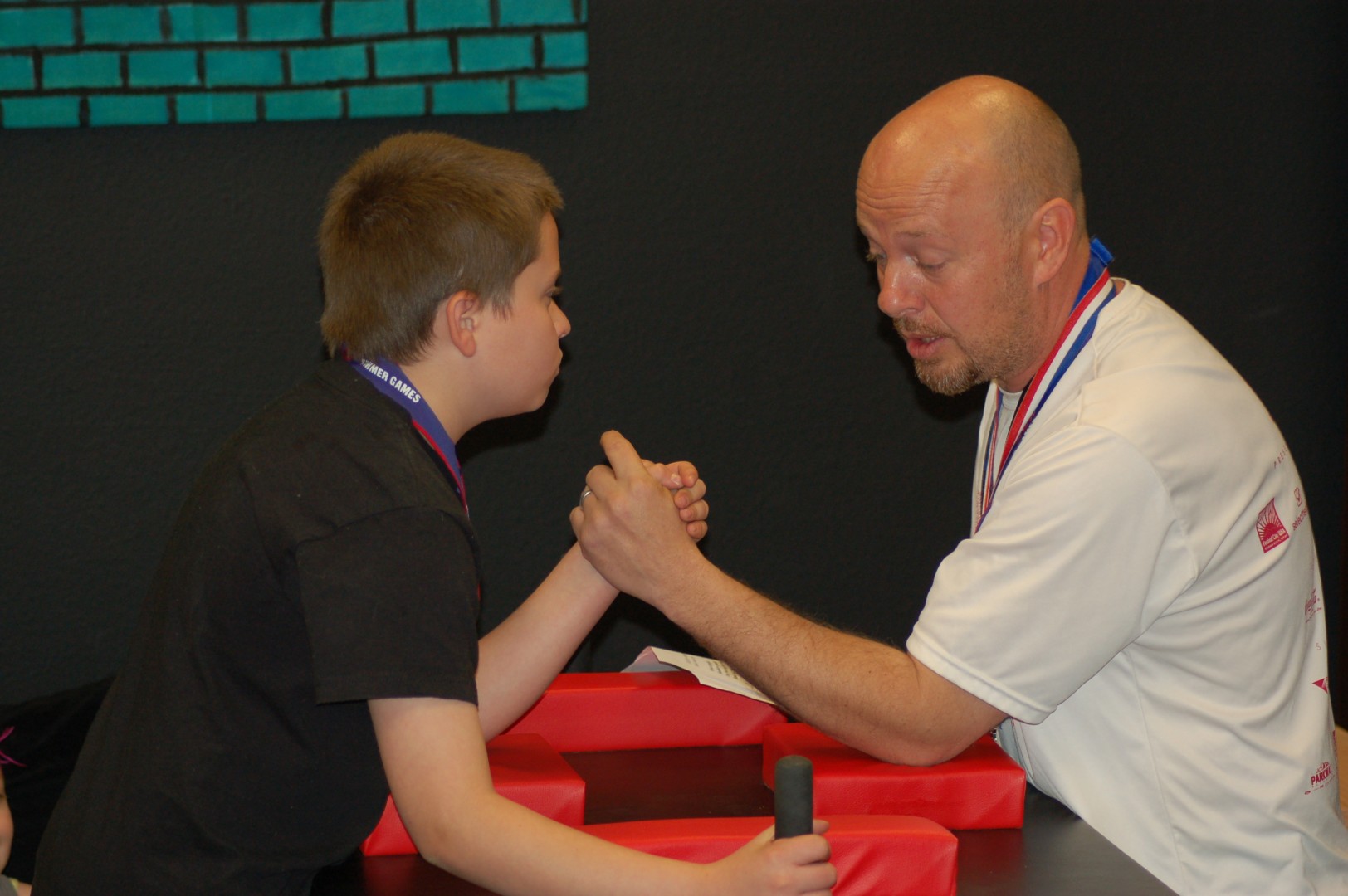 Jarett Kirby and Jeff Kirby demonstrate to the students the proper form for arm wrestling at an assembly held at Bloomington Elementary, St. George, Utah, April 4, 2014 | Photo by Hollie Reina, St. George News