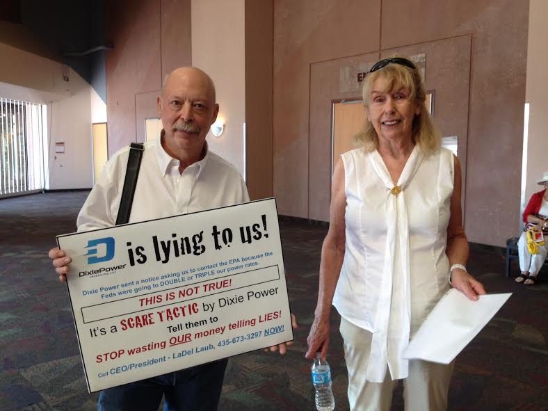 Gary Engelman and Shirley Nelson hold protest signs and information at the Dixie Power annual dinner and meeting held at the Dixie Center, St. George, Utah, May 28, 2014 | Photo by Hollie Reina, St. George News