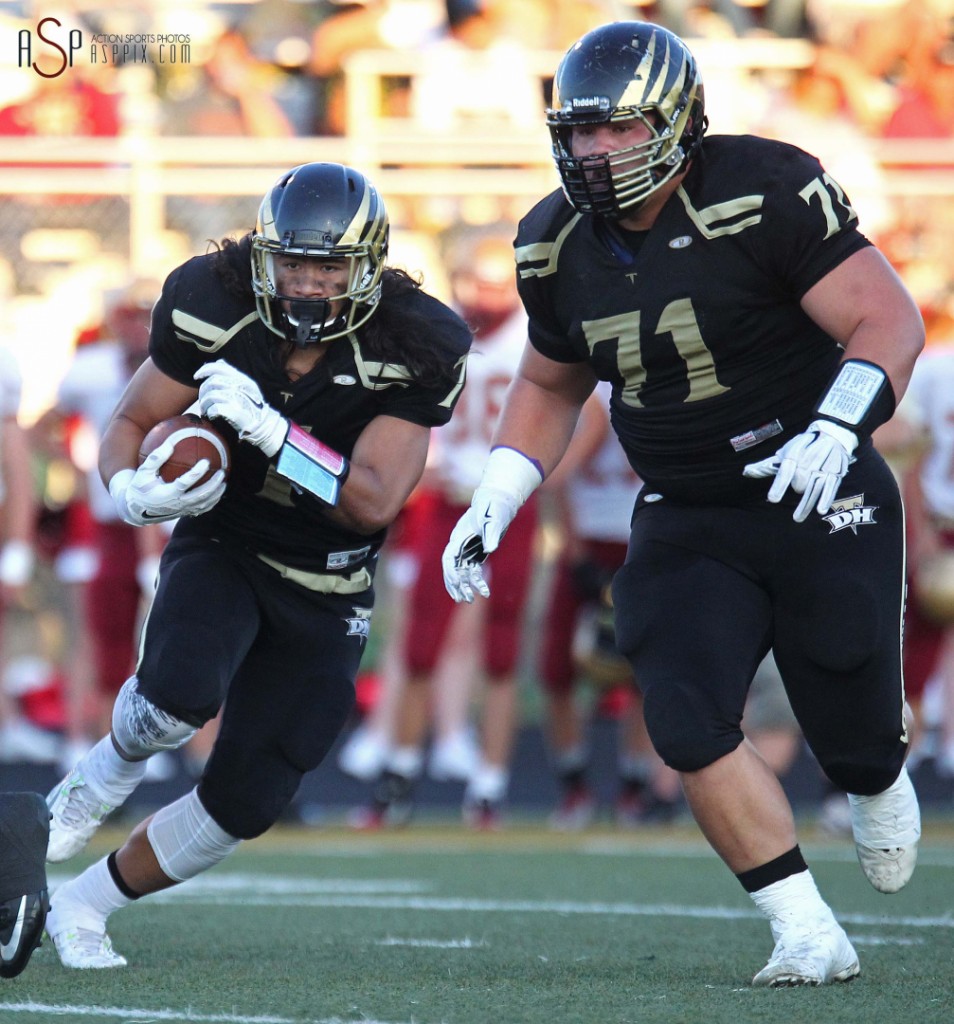 Gabe Sewell runs behind the blocking of his cousin, Boogie Sewell (71), Cedar at Desert Hills, St. George, Utah, September 12, 2014 | Photo by Robert Hoppie, ASPpix.com, St. George News