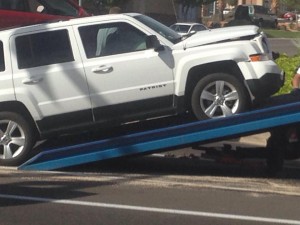 A Jeep Patriot is towed from an accident scene after it hit into a Honda Civic that ran a red-light, St. George, Utah, Oct. 23, 2014 |Photo by Holly Coombs, St. George News