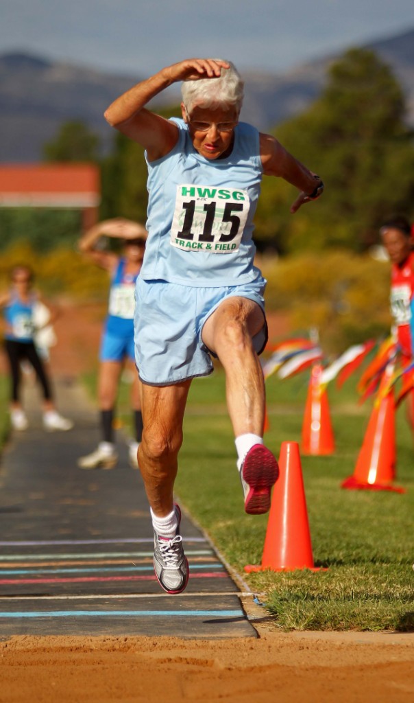 Ethel Lehman launches off the board during the triple jump at the Huntsman Senior Games Track and Field competition, St. George, Utah, Oct. 8, 2014 | Photo by Robert Hoppie, ASPpix.com, St. George News