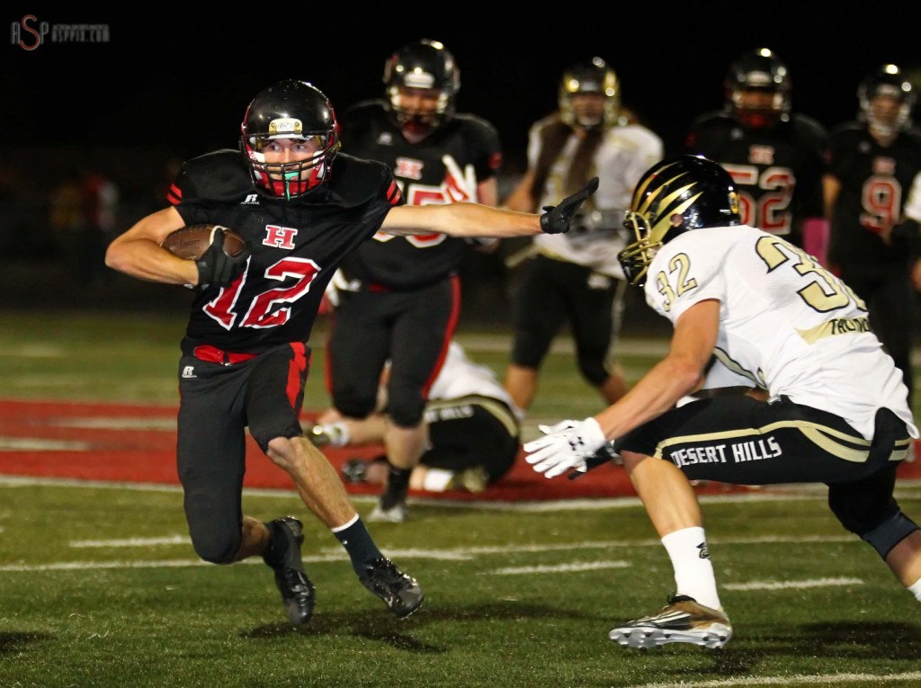 Hurricanes Noah Elison puts a stiff arm on  Zak Fuchs, Desert Hills vs. Hurricane,  St. George, Utah, Oct. 24, 2014 | Photo by Robert Hoppie, ASPpix.com, St. George News