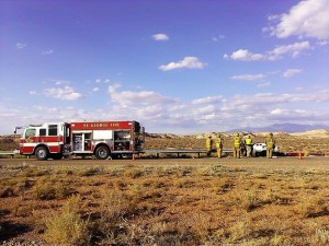 St. George firefighters stand on scene near the Corvette that crashed on state Route 7 just west of the River Road onramp, Utah, Oct. 25, 2014 | Photo by Aspen Stoddard, St. George News