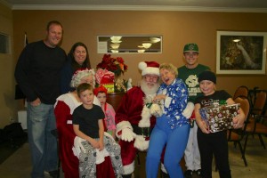 A family and a senior pose with Santa during the 2013 santa for seniors event, St. George, Utah,  undated | Photo courtesy of Jennifer Shakespeare, for St. George News