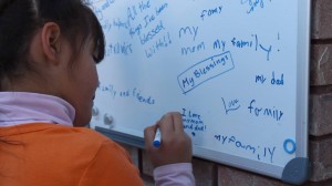 Sharon Jordan signs the gratitude board, Hildale, Utah, Nov. 29, 2014 | Photo by Leanna Bergeron, St. George News