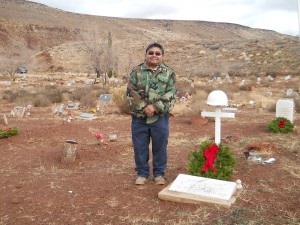 Glenn Rogers, councilman for the Shivwits Band of Paiutes, stands beside the grave of his uncle Crawford Snow at the Shivwits Cemetery, on the Shivwits Indian Reservation, Utah, Dec. 13, 2014 | Photo by Aspen Stoddard, St. George News
