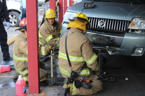 Emergency responders work to remove a shopping cart stuck under an SUV at IFA Country Store, St. George, Utah, Dec. 24, 2014 | Photo by Devan Chavez, St. George News