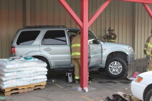 Emergency responders work to remove a shopping cart stuck under an SUV at IFA Country Store, St. George, Utah, Dec. 24, 2014 | Photo by Devan Chavez, St. George News