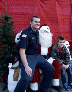 Iron County "Shop with a Cop"  volunteers stop to take a picture with the children they shopped with and Santa Claus, Cedar City, Utah, Dec. 13, 2014 | Photo by Carin Miller, St. George News