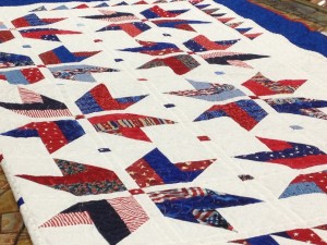 A patriotic quilt made by Wilma Courtney and Colleen Willis is shown to DSU President Richard Williams during a check presentation for the "Embracing Our Heroes Scholarship" which benefits veterans and spouses of veterans. St. George, Utah, Dec. 8, 2014 | Photo by Hollie Reina, St. George News