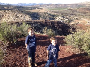 L-R, Hunter Reina and Conor Reina smile at the top of the cinder cone with the crater in the background, St. George, Utah, November, 2014 | Photo by Hollie Reina, St. George News