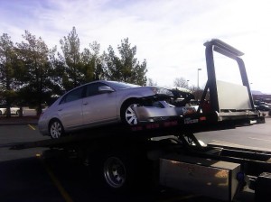 The Toyota Avalon is towed after a collision that occurred in the parking lot near 700 West Telegraph St. in Washington City, Utah, Dec. 21, 2014 | Photo by Aspen Stoddard, St. George News
