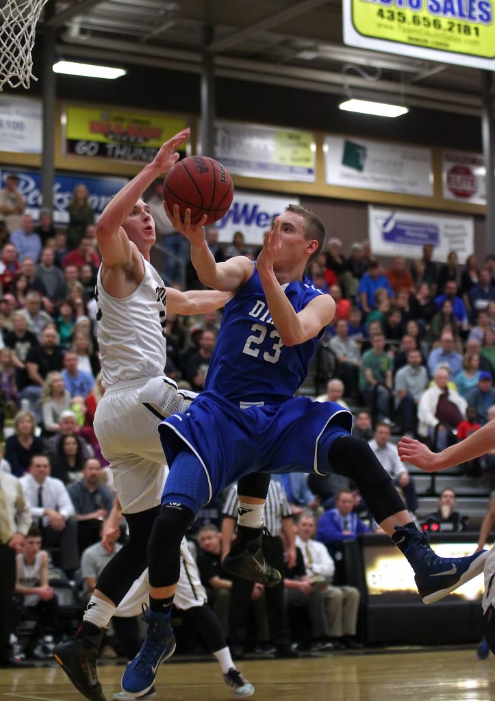 Jake Hawes (23) with a tough shot against Quincy Mathews, Dixie vs. Desert Hills, Boys Basketball, St. George, Utah, Jan. 28, 2015 | Photo by Robert Hoppie, ASPpix.com, St. George News