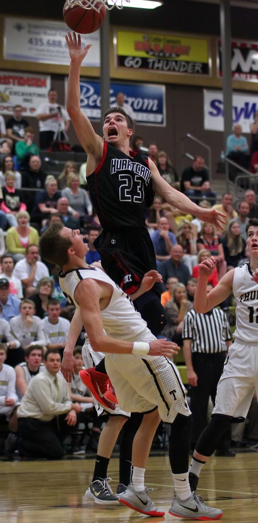 Kaden Langston (23) flies to the hoop over Max Mills, Langston would be called for a charge on this play, Hurricane vs. Desert Hills, Boys Basketball, St. George, Utah, Feb. 13, 2015 | Photo by Robert Hoppie, ASPpix.com, St. George News