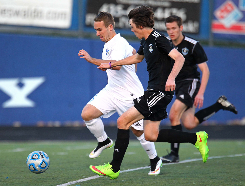 Dixie's Colton Atkin (white jersey) heads for the goal, Canyon View vs. Dixie, Boys Soccer, St. George, Utah, Mar. 12, 2015 | Photo by Robert Hoppie, ASPpix.com, St. George News