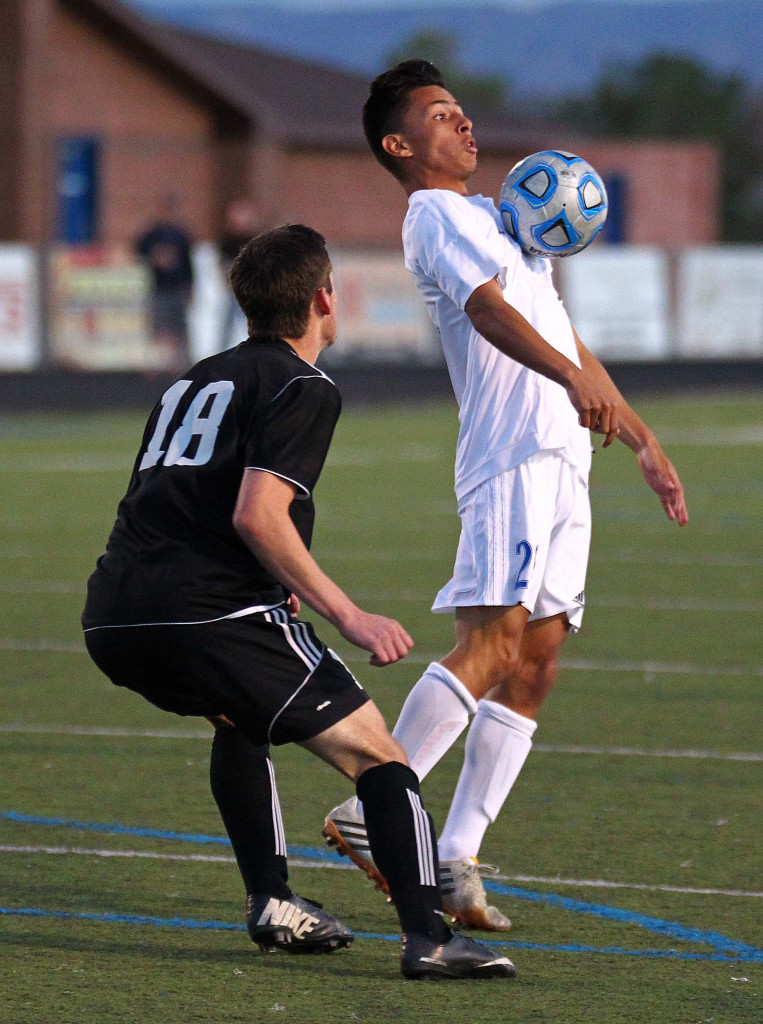 Jose "Pepe" Garcia (white jersey) takes control of the ball for Dixie in front of jace Fowler, Canyon View vs. Dixie, Boys Soccer, St. George, Utah, Mar. 12, 2015 | Photo by Robert Hoppie, ASPpix.com, St. George News