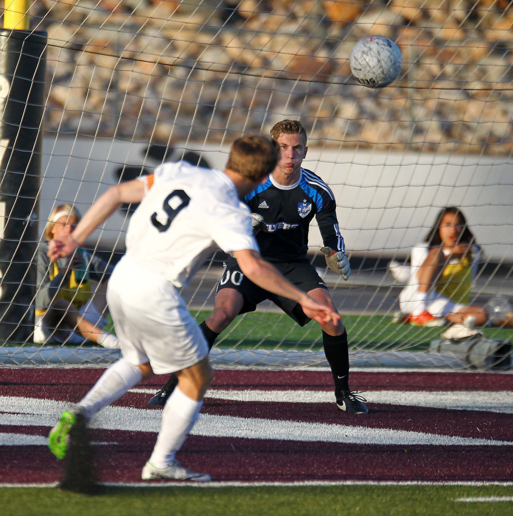 Pine View's Michael Wade (9) fires a shot at Dixie goalkeeper Ethan Poulton. Poulton was injured and taken to the hospital with a concussion later in the game. Dixie vs. Pine View, Soccer, St. George, Utah, Mar. 26, 2015 | Photo by Robert Hoppie, ASPpix.com, St. George News