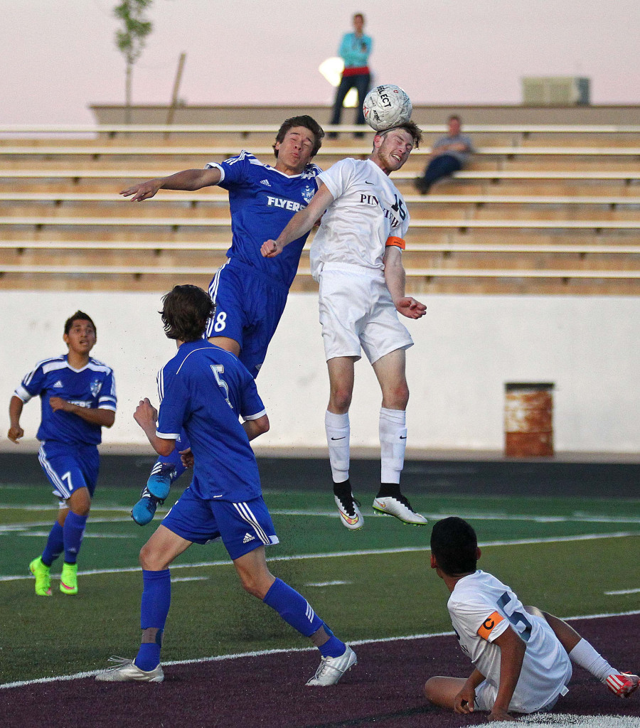 Ethan Baer heads a ball for Pine View as Tyler Bennett defends for Dixie, Dixie vs. Pine View, Soccer, St. George, Utah, Mar. 26, 2015 | Photo by Robert Hoppie, ASPpix.com, St. George News