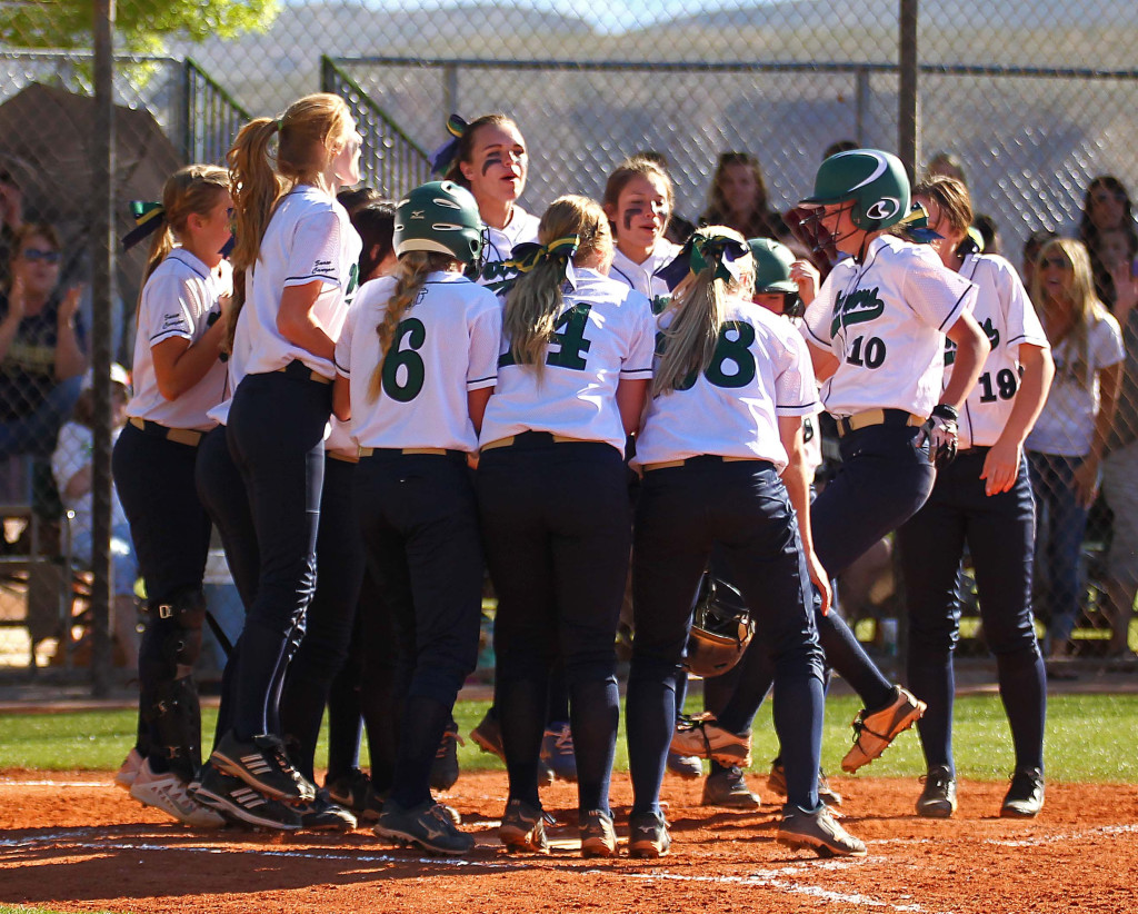 Snow Canyon's Katelyn Flowers (10) is greeted by her teammates at home after she launched a home run, Dixie vs. Snow Canyon, Softball, St. George, Utah, Mar. 27, 2015 | Photo by Robert Hoppie, ASPpix.com, St. George News