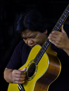 Dixie Forum presenter Tinh Mahoney as he plays his guitar, location and date unspecified | Photo courtesy of Dixie State University, St. George News