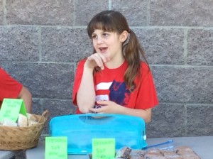 Summer Eardley waits for customers to buy her baked goods at her class bake sale, March 6, 2015 | Photo by Holly Coombs, St. George News
