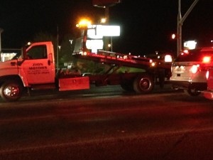 A motorcycle is towed after it was rear-ended in a hit-and-run accident on Dixie Drive, St. George, Utah, March 27, 2015 | Photo by Holly Coombs, St. George News