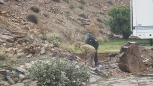 Washington County Bomb Squad member inspecting a blasting hole where abandoned, undetonated explosives await removal, Hurricane, Utah, March 2, 2015 | Photo by Mori Kessler, St. George News