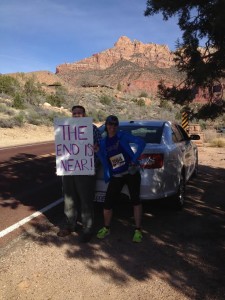 Spectators hold up funny signs to encourage runners at the Zion Half Marathon, Springdale, Utah, March 14, 2015 | Photo courtesy of Hollie Reina, St. George News