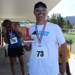 Eric Lewis displaying his trophy after winning the quarter marathon, Cedar City, Utah, May 17, 2014 | Photo courtesy of Iron County Children's Justice Center