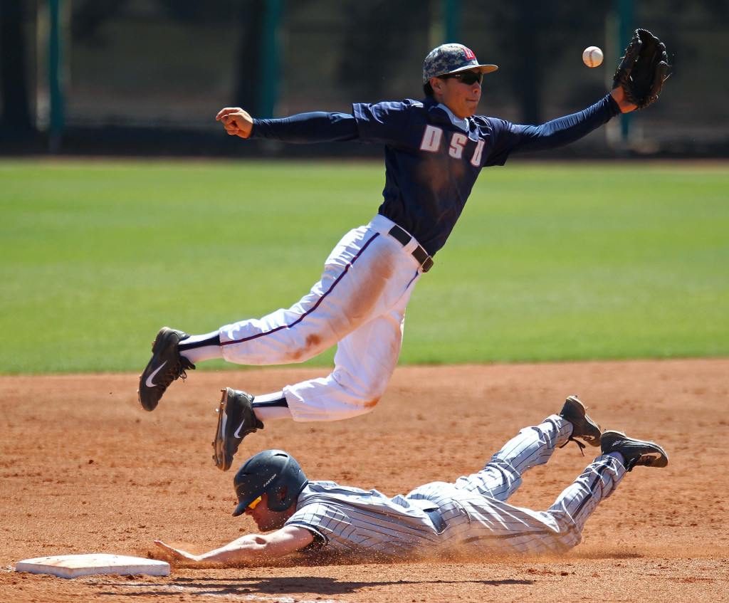 Dixie State third baseman Yuto Kata leaps for a high throw, Dixie State University vs. California Baptist University, Baseball, St. George, Utah, Apr. 11, 2015 | Photo by Robert Hoppie, ASPpix.com, St. George News