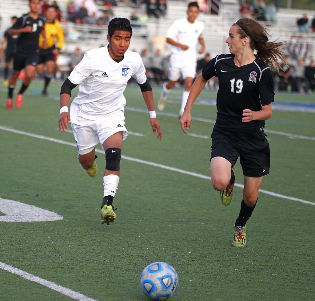 Dixie's Luis Bernabe and Pine View's Kalob Dudley (19) chase down a loose ball, Pine View vs. Dixie, Soccer, St. George, Utah, Apr. 14, 2015 | Photo by Robert Hoppie, ASPpix.com, St. George News