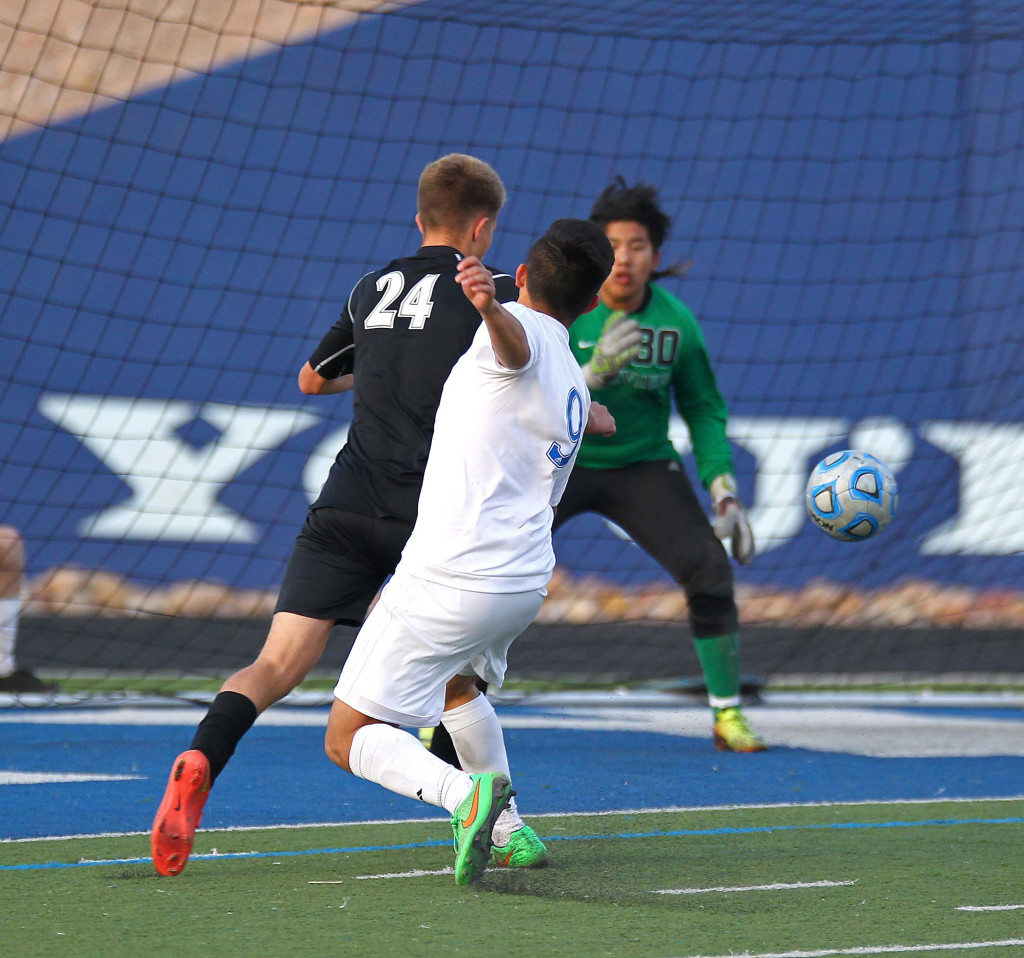 Dixie's Jonny Acosta (9) fires a shot on goal with Pine View's Easton Householder (24) defending, Pine View vs. Dixie, Soccer, St. George, Utah, Apr. 14, 2015 | Photo by Robert Hoppie, ASPpix.com, St. George News