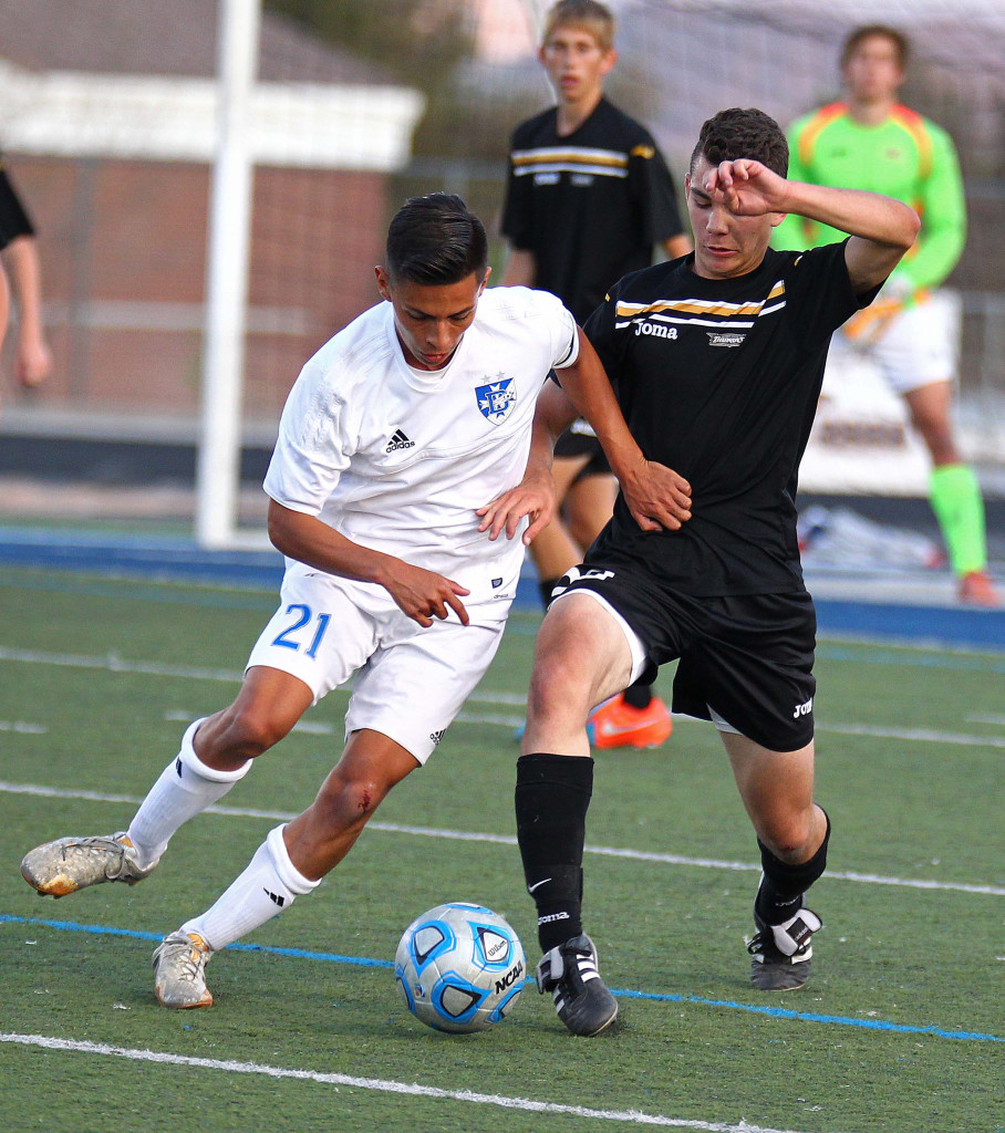 Jose "Pepe" Garcia (21) and Alec Perez battle for a ball, Desert Hills vs. Dixie, Soccer, St. George, Utah, Mar. 31, 2015 | Photo by Robert Hoppie, ASPpix.com, St. George News