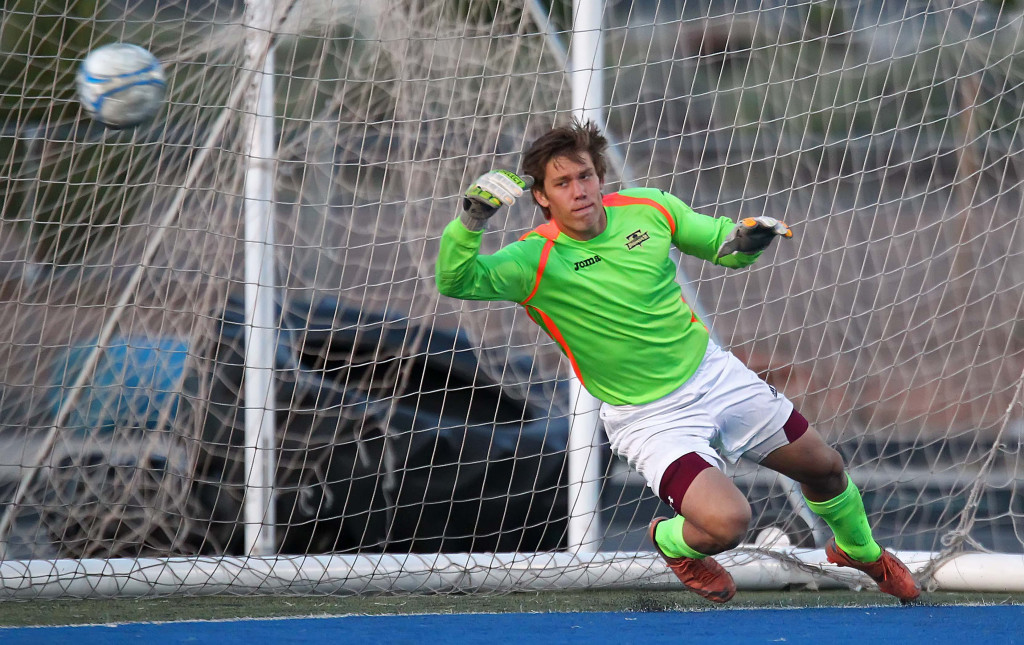 Desert Hills goalkeeper Trevor Ottenschot attempts a save at a penalty kick in the second half, Desert Hills vs. Snow Canyon, Soccer, St. George, Utah, Apr. 7, 2015 | Photo by Robert Hoppie, ASPpix.com, St. George News