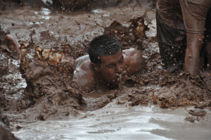 Man swimming through the mud during the Great Race, St. George, Utah, date unspecified | Photo courtesy of Dixie State University, St. George News