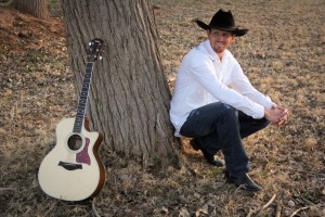 Eric Dodge sitting by his guitar, location and date unspecified | Photo courtesy of Marianne Hamilton, St. George News