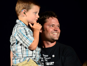 Justin Osmond with a hearing-impaired boy at the Utah Pioneer Days celebration, July 2012, West Jordan, Utah | Photo courtesy of Justin Osmond, St. George News 