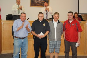 L - R Mayor John Bramall and the city council applaud Officer Spence Lundell, Jared Elison, and Bryce King for helping an 11-year-old visitor replace his stolen baseball equipment, Hurricane City Council, Hurricane, Utah, April 16, 2015 | Reuben Wadsworth, St. George News