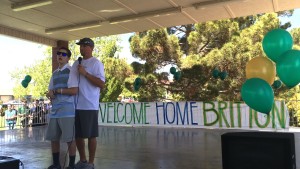 Britton Shipp and his father, Jesse Shipp, and the stage address the crowd gathered to welcome Britton home after over 160 days in the hospital, Santa Clara, April 11, 2015 | Photo by Mori Kessler, St. George News