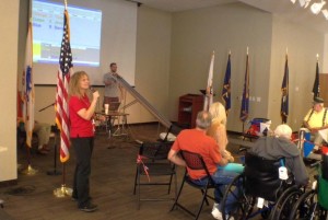 Vie Van Noy, recreation director for the Southern Utah Veterans Home, announces the pinewood derby races, Ivins, Utah, April 18, 2015 | Photo by Ric Wayman, St. George News