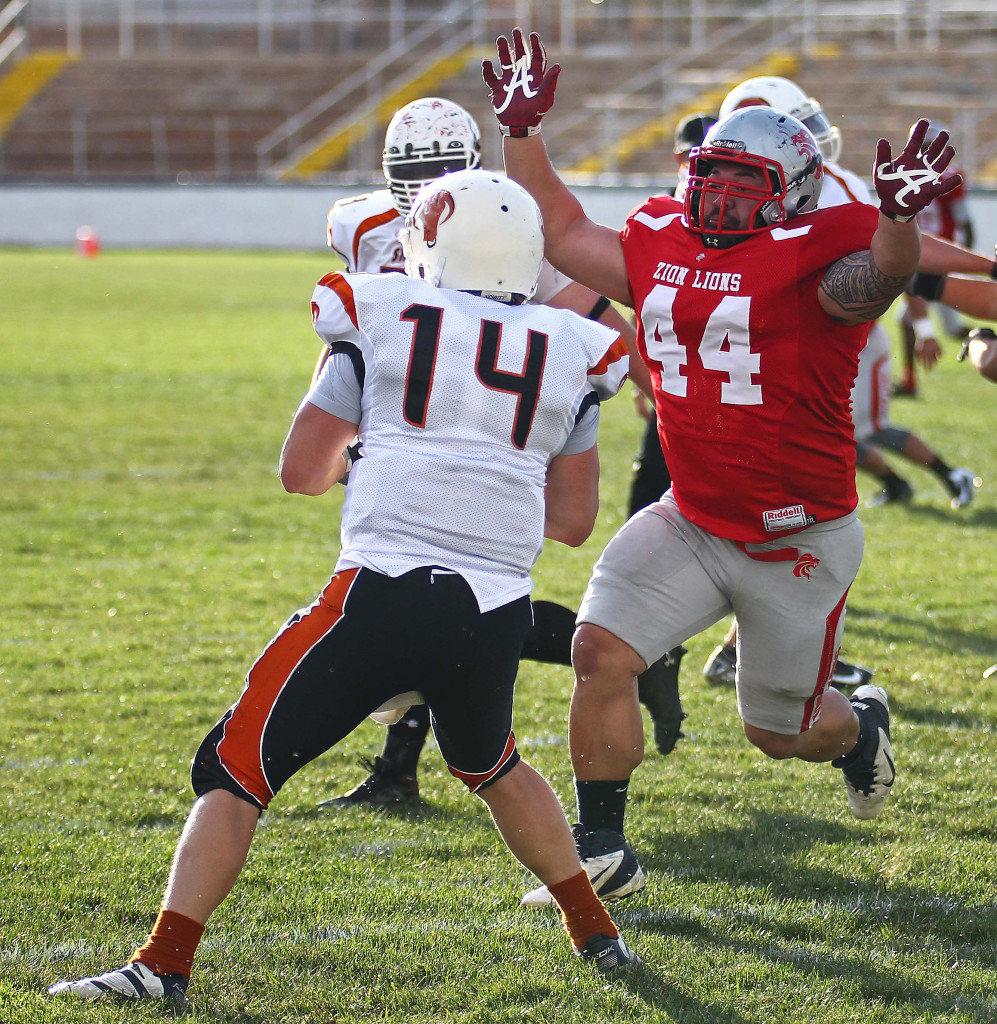 Zion's Joe Feula (44) puts pressure on the Logan quarterback,  Logan Stampede vs. Zion Lions, Football, St. George, Utah, May 2, 2015 | Photo by Robert Hoppie, ASPpix.com, St. George News