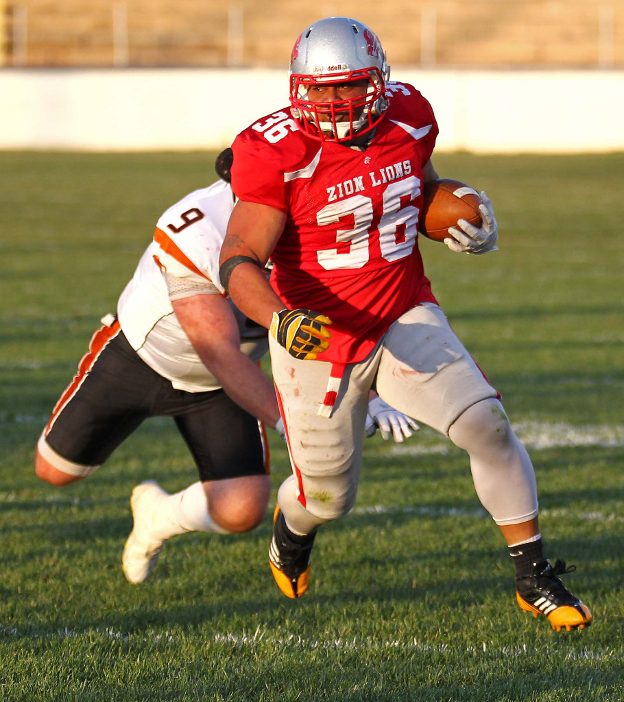 Sione Tapuosi (36) breaks out of a tackle and finds some yardage, Logan Stampede vs. Zion Lions, Football, St. George, Utah, May 2, 2015 | Photo by Robert Hoppie, ASPpix.com, St. George News