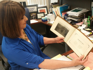 Dixie High School Principal Sharla Campbell shows a 1913 Dixie yearbook as an example of the schools long history, St. George, Utah, May 19, 2015 | Photo by Julie Applegate, St. George News