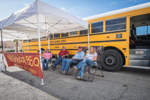 (L-R) Skeeter Allen, Terry Bellow, Doug Rucker and Shandi Rucker lounge in front of the Old School BBQ Bus. 